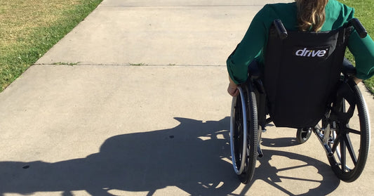 Female wheelchair user discussing bladder management options with healthcare provider